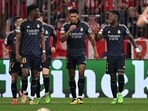 Real Madrid's Brazilian forward #07 Vinicius Junior (R) celebrates scoring with teammates during the UEFA Champions League semi-final first leg football match vs FC Bayern Munich