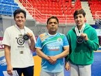 Reetika Hooda (left) and Anshu Malik (right) with national coach Virender Dahiya after qualifying for Paris Olympics
