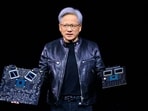 Nvidia's CEO Jensen Huang displays products on-stage during the annual Nvidia GTC Artificial Intelligence Conference at SAP Center in San Jose, California.