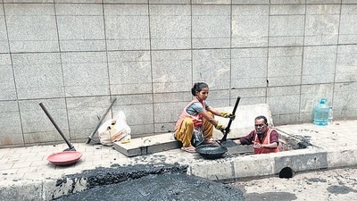 A worker inside a drain in Tilak Nagar, Chembur, wearing only an orange safety vest A worker inside a drain in Tilak Nagar, Chembur, wearing only an orange safety vest