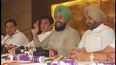 Congress leaders Partap Singh Bajwa (C) with Devendra Yadav (L), Congress candidate from Amritsar Gurjeet Singh Aujla in Amritsar on Thursday (Sameer Sehgal/HT)
