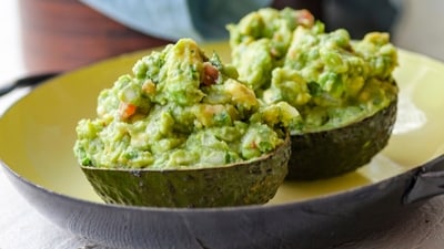 A recipe for guacamole, served in an avocado shell, appears in New York in June 2019. (Carrie Crow via AP) A recipe for guacamole, served in an avocado shell, appears in New York in June 2019. (Carrie Crow via AP)