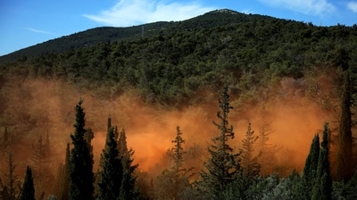 Smoke from smoke grenades rise through the forest during a disaster risk training exercise to effectively deal with wildfires, in Athens, Greece. Travelling to Greece this summer? Watch out for intense wildfire threat amid climate change warning (Photo by REUTERS/Louiza Vradi)