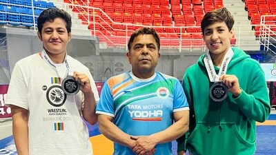 Reetika Hooda (left) and Anshu Malik (right) with national coach Virender Dahiya after qualifying for Paris Olympics (HT) Reetika Hooda (left) and Anshu Malik (right) with national coach Virender Dahiya after qualifying for Paris Olympics (HT)