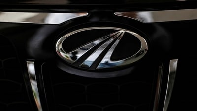 Mahindra & Mahindra share price: The logo of Mahindra and Mahindra is seen on a car at a showroom in Mumbai, India. (Reuters)