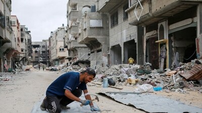 A Palestinian man fixes tin sheets used for temporary sheltering on a road lined with destroyed buildings in Khan Yunis in the southern Gaza Strip on May 2, 2024, amid the ongoing conflict between Israel and the Hamas movement. (AFP) A Palestinian man fixes tin sheets used for temporary sheltering on a road lined with destroyed buildings in Khan Yunis in the southern Gaza Strip on May 2, 2024, amid the ongoing conflict between Israel and the Hamas movement. (AFP)