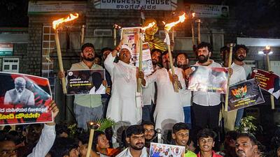 People take part in a torch light protest against Prajwal Revanna, in Bengaluru, on Thursday. (PTI) People take part in a torch light protest against Prajwal Revanna, in Bengaluru, on Thursday. (PTI)
