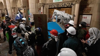 Protesters reinforce the barricades set up against one of the doors of Royce Hall as police started clearing a pro-Palestinian encampment on the campus of the University of California, Los Angeles (UCLA) in Los Angeles, California, early on May 2, 2024. Hundreds of police tore down protest barricades and began arresting students early Thursday at the University of California, Los Angeles �- the latest flashpoint in an eruption of protest on US campuses over Israel's war against Hamas in Gaza. (Photo by ETIENNE LAURENT / AFP) (AFP) Protesters reinforce the barricades set up against one of the doors of Royce Hall as police started clearing a pro-Palestinian encampment on the campus of the University of California, Los Angeles (UCLA) in Los Angeles, California, early on May 2, 2024. Hundreds of police tore down protest barricades and began arresting students early Thursday at the University of California, Los Angeles �- the latest flashpoint in an eruption of protest on US campuses over Israel's war against Hamas in Gaza. (Photo by ETIENNE LAURENT / AFP) (AFP)