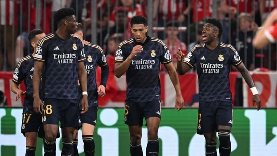 Real Madrid's Brazilian forward #07 Vinicius Junior (R) celebrates scoring with teammates during the UEFA Champions League semi-final first leg football match vs FC Bayern Munich (AFP)