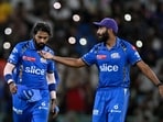 Mumbai Indians' Jasprit Bumrah (R) gestures as captain Hardik Pandya looks on during the Indian Premier League (IPL) Twenty20 cricket match