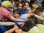 Security personnel detain wrestler Sakshi Malik during a protest march towards new Parliament building on May 28, 2023. (PTI)