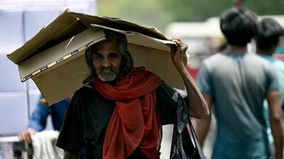 A man takes shelter under a cardboard sheet from the scorching sun on a hot summer afternoon in New Delhi on May 3. (AFP) A man takes shelter under a cardboard sheet from the scorching sun on a hot summer afternoon in New Delhi on May 3. (AFP)