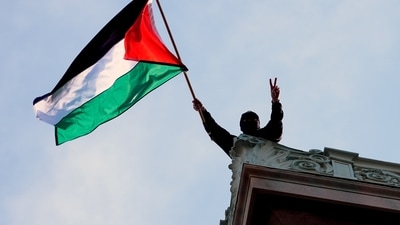 FILE - A student protester waves a Palestinian flag above Hamilton Hall on the campus of Columbia University, Tuesday, April 30, 2024, in New York. (Pool Photo/Mary Altaffer, File) (AP) FILE - A student protester waves a Palestinian flag above Hamilton Hall on the campus of Columbia University, Tuesday, April 30, 2024, in New York. (Pool Photo/Mary Altaffer, File) (AP)