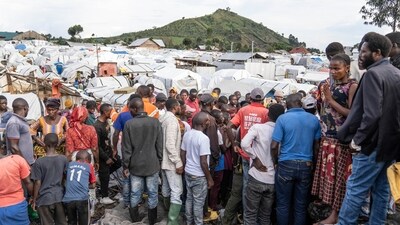 People gather at the side of an explosion in a refugee camp on the outskirts of Goma, Democratic Republic of the Congo. (AP) People gather at the side of an explosion in a refugee camp on the outskirts of Goma, Democratic Republic of the Congo. (AP)