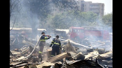 Firefighters trying to douse a fire that gutted 300 shanties in a slum at Saraswati Kunj near Sector-53 in Gurugram on Friday. (Parveen Kumar/HT PHOTO.) Firefighters trying to douse a fire that gutted 300 shanties in a slum at Saraswati Kunj near Sector-53 in Gurugram on Friday. (Parveen Kumar/HT PHOTO.)