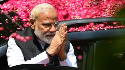 Indian Prime Minister and leader of the Bharatiya Janata Party (BJP) Narendra Modi gestures to supporters as he arrives to file his election nomination papers at district collectorate office, in Varanasi on April 26, 2019. (AFP File)