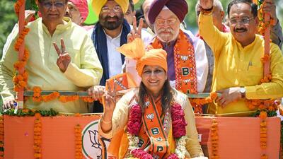 Kamaljeet Sehrawat (sitting on the truck) — BJP candidate from West Delhi constituency — leads a roadshow before filing her nomination papers at Vikas Puri on Thursday. (Sanchit Khanna/HT Photo)