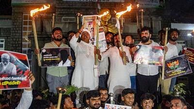 People take part in a torch light protest against Prajwal Revanna, in Bengaluru. (PTI photo) People take part in a torch light protest against Prajwal Revanna, in Bengaluru. (PTI photo)