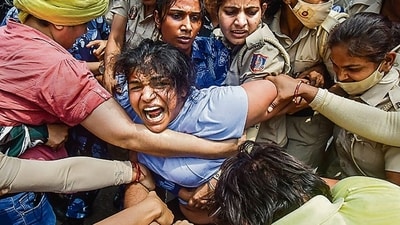 Security personnel detain wrestler Sakshi Malik during a protest march towards new Parliament building on May 28, 2023. (PTI)