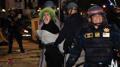 Police make an arrest as they face-off with pro-Palestinian students after destroying part of the encampment barricade on the campus of the University of California, Los Angeles (UCLA). (AFP) Police make an arrest as they face-off with pro-Palestinian students after destroying part of the encampment barricade on the campus of the University of California, Los Angeles (UCLA). (AFP)