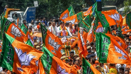 Uttarakhand CM Pushkar Singh Dhami held a rally with Delhi Bharatiya Janata Party (BJP) chief Virendra Sachdeva and party National Secretary Alka Gurjar before the nomination filing of party candidate Ramvir Singh Bidhuri, from South Delhi, at Lado Sarai, in New Delhi.(ANI)