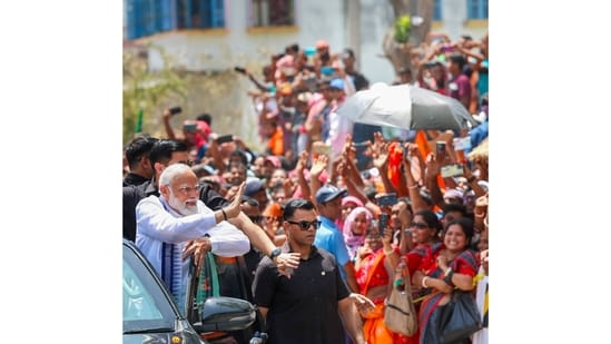 PM Narendra Modi waves to supporters upon arrival for a public meeting, in Krishnanagar, West Bengal.(PTI)