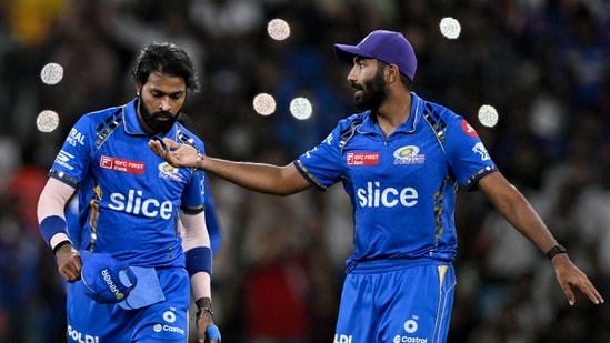 Mumbai Indians' Jasprit Bumrah (R) gestures as captain Hardik Pandya looks on during the Indian Premier League (IPL) Twenty20 cricket match (AFP)