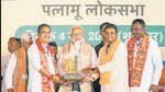 Prime Minister Narendra Modi being felicitated by BJP leaders during a public meeting in Palamu district on Saturday. (PTI)
