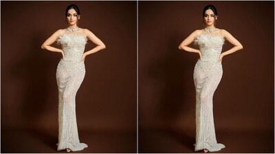 Her glam outfit is from Ivan Young and comes in a lovely shade of ivory. It has an off-the-shoulder neckline embellished with fur and a body-con fit that accentuates her curves. The intricate sequin embellishment that adorns the fabric adds to the oomph factor. (Instagram/@manushi_chhillar) Her glam outfit is from Ivan Young and comes in a lovely shade of ivory. It has an off-the-shoulder neckline embellished with fur and a body-con fit that accentuates her curves. The intricate sequin embellishment that adorns the fabric adds to the oomph factor. (Instagram/@manushi_chhillar)