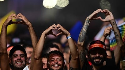 Fans hold up their hands in the shape of hearts during Madonna's performance at Copacabana beach. The show marked the final stop on her Celebration Tour, which was in celebration of her 40 years in music. (AFP) Fans hold up their hands in the shape of hearts during Madonna's performance at Copacabana beach. The show marked the final stop on her Celebration Tour, which was in celebration of her 40 years in music. (AFP)