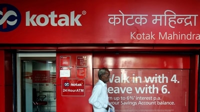 FILE PHOTO: A man walks past the Kotak Mahindra Bank branch in New Delhi, India, September 6, 2017. REUTERS/Adnan Abidi)