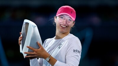 Poland's Iga Swiatek celebrates with the trophy after winning her final match against Belarus' Aryna Sabalenka (REUTERS)