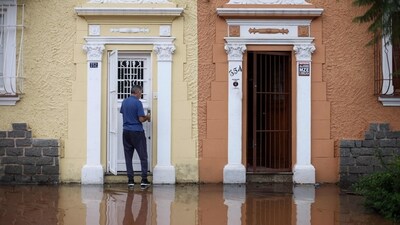 A man stands at the entrance of a flooded house in the São Geraldo neighbourhood of Porto Alegre, Rio Grande do Sul, Brazil. The inundation has resulted in the suspension of all flights at the Porto Alegre International Airport until further notice. (AFP) A man stands at the entrance of a flooded house in the São Geraldo neighbourhood of Porto Alegre, Rio Grande do Sul, Brazil. The inundation has resulted in the suspension of all flights at the Porto Alegre International Airport until further notice. (AFP)