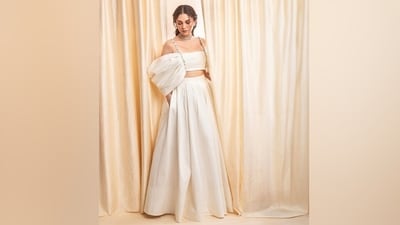 Aditi paired the draped blouse with an ivory voluminous skirt featuring a mid-rise waistline, a plated A-line silhouette, a floor-length hem, and pockets on the side. (Instagram) Aditi paired the draped blouse with an ivory voluminous skirt featuring a mid-rise waistline, a plated A-line silhouette, a floor-length hem, and pockets on the side. (Instagram)