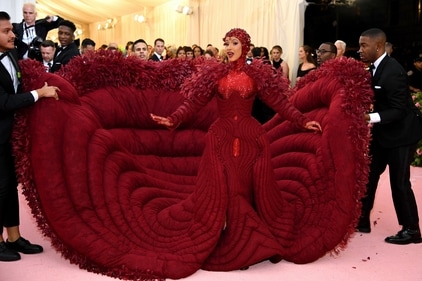 Cardi brought the red to the red carpet in an absolutely massive, feathered Thom Browne creation. (Getty images) Cardi brought the red to the red carpet in an absolutely massive, feathered Thom Browne creation. (Getty images)