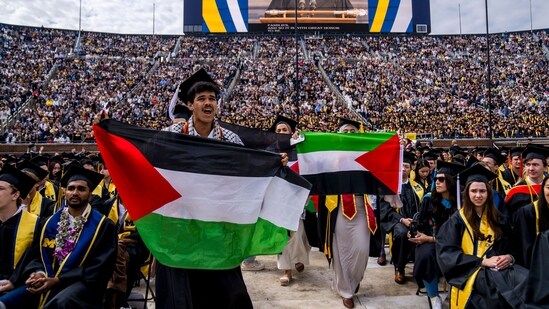 Students protest in support of Palestine during the University of Michigan's Spring Commencement ceremony on May 4, 2024 at Michigan Stadium in Ann Arbor, Michigan. A group of students called for the University of Michigan to divest from companies with ties to Israel during the spring commencement ceremony. Nic Antaya/Getty Images/AFP (Photo by Nic Antaya / GETTY IMAGES NORTH AMERICA / Getty Images via AFP) (Getty Images via AFP)