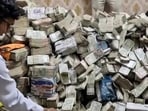 ED officials with the unaccounted cash in Ranchi. (ANI Photo) ED officials with the unaccounted cash in Ranchi. (ANI Photo)