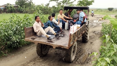 Polling officials carrying EVMs and other polling materials leave for their booths on a tractor at Hajo Tapabori Chor, in Kamrup, Assam. (ANI) Polling officials carrying EVMs and other polling materials leave for their booths on a tractor at Hajo Tapabori Chor, in Kamrup, Assam. (ANI)