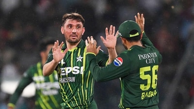 Pakistan's Zaman Khan (L) celebrates with captain Babar Azam (R) after taking the wicket of New Zealand's Tom Blundell (AFP)