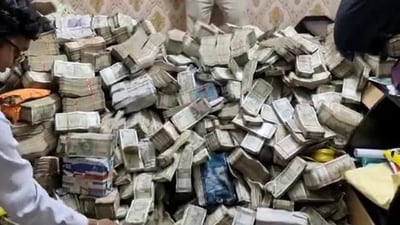 ED officials with the unaccounted cash in Ranchi. (ANI Photo) ED officials with the unaccounted cash in Ranchi. (ANI Photo)