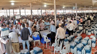 Election Commission officers gather for EVM systems distributions eve of voting day for Lok Sabha election of Sangli constituency at Sangli on Monday. (Uday Deolekar/HT Photo)