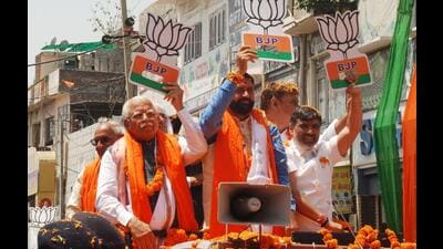 Haryana chief minister Nayab Singh Saini and former CM Manohar Lal Khattar during a roadshow dubbed “Vijay Yatra” in an open decorated vehicle in Karnal on Monday. (HT Photo) Haryana chief minister Nayab Singh Saini and former CM Manohar Lal Khattar during a roadshow dubbed “Vijay Yatra” in an open decorated vehicle in Karnal on Monday. (HT Photo)