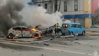 Firefighters extinguish burning cars after shelling in Belgorod, Russia. (AP)