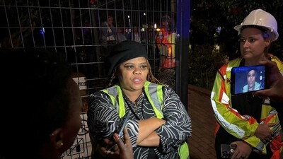 Theresa Jeyi who claims to have witnessed a building under construction collapse, talks to media at the scene in George, South Africa (REUTERS)