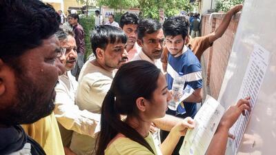 Students check their examination room numbers as they appear for the NEET exam, in Bikaner on Sunday (ANI) Students check their examination room numbers as they appear for the NEET exam, in Bikaner on Sunday (ANI)