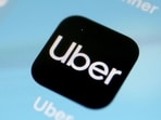 A picture taken on April 11, 2019 shows the global ride-hailing giant, Uber application on a smart phone in Cologne. (Photo by Oliver Berg / dpa / AFP) / Germany OUT (AFP)