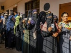 People wait in queues to cast their votes at a polling station during the 3rd phase of Lok Sabha polls, in Karnataka on Tuesday. People wait in queues to cast their votes at a polling station during the 3rd phase of Lok Sabha polls, in Karnataka on Tuesday.