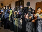 People wait in queues to cast their votes at a polling station during the 3rd phase of Lok Sabha polls, in Karnataka, Tuesday. (PTI)