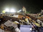An Oklahoma State Highway Patrol trooper searches storm damage Tuesday, May 7, 2024 in Barnsdall, Okla. (Mike Simons/Tulsa World via AP) An Oklahoma State Highway Patrol trooper searches storm damage Tuesday, May 7, 2024 in Barnsdall, Okla. (Mike Simons/Tulsa World via AP)