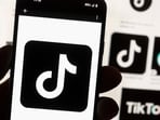 FILE - The TikTok logo is displayed on a mobile phone in front of a computer screen, Oct. 14, 2022, in Boston. On Tuesday, May 7, 2024, TikTok and its Chinese parent company ByteDance filed suit against the U.S. federal government to challenge a law that would force the sale of ByteDance's stake or face a ban, saying that the law is unconstitutional. (AP Photo/Michael Dwyer, File)